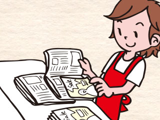 新聞にチラシを挟む作業をしている女性